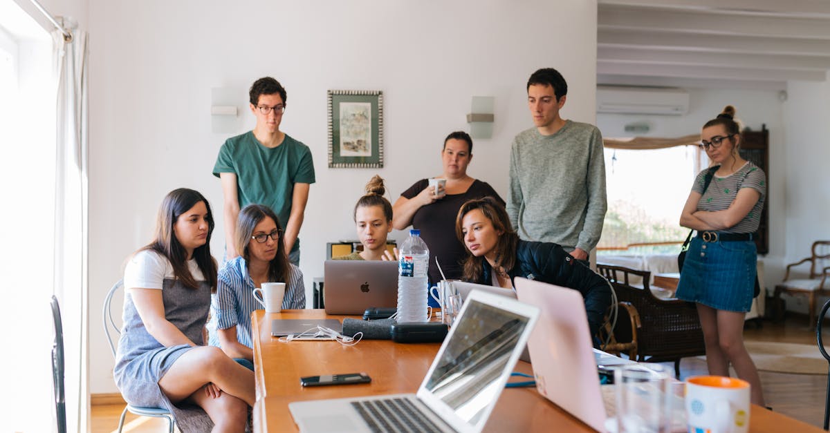 Group of young professionals engaged in a collaborative meeting in a modern office setting.